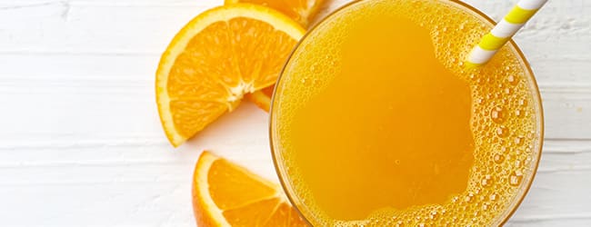 Glas of orange juice with slices of orange