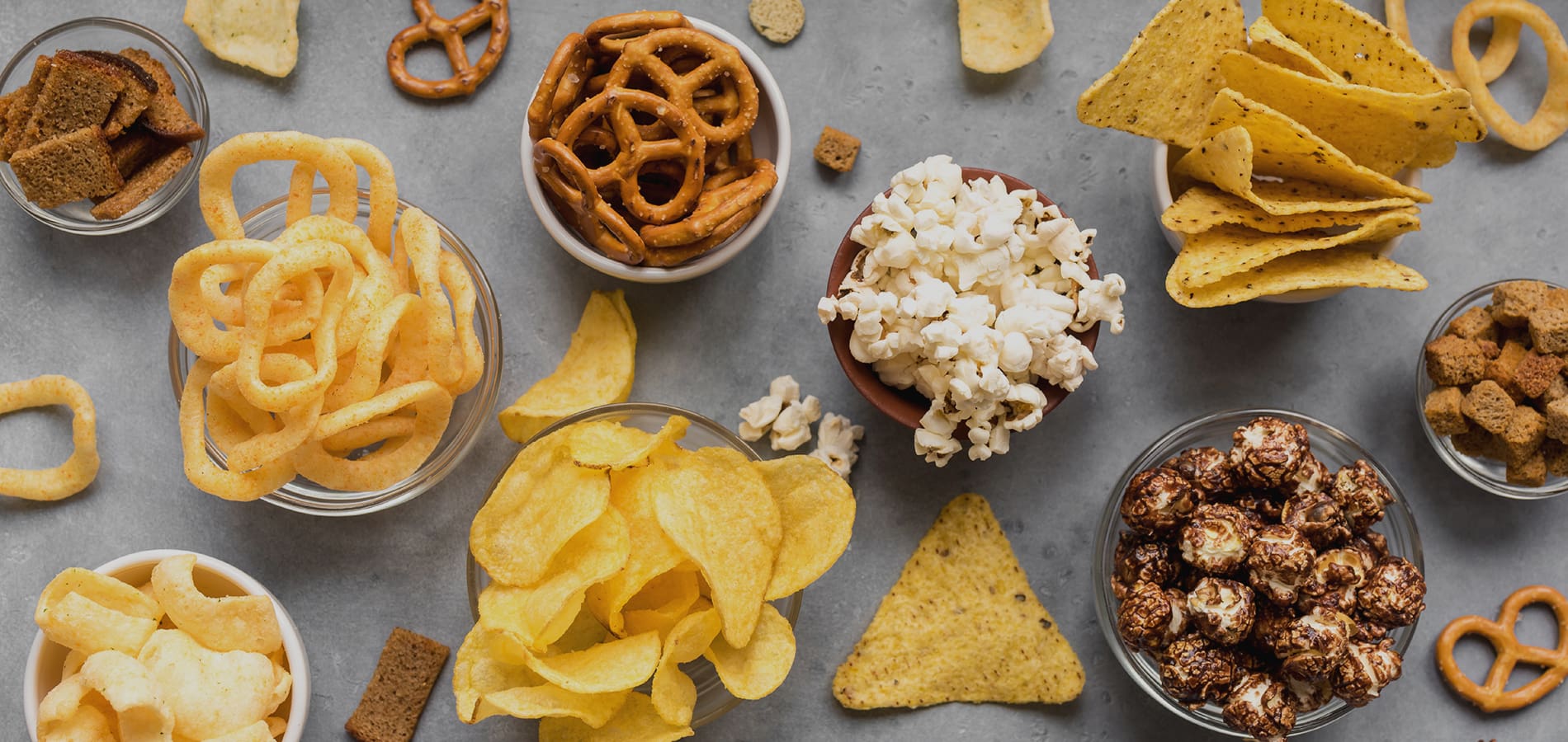 Bowls of savoury snacks like chips/crisps and popcorn