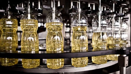bottles being filled with oil in factory