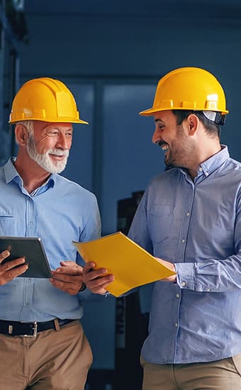 two men walking through magazine full of supplies