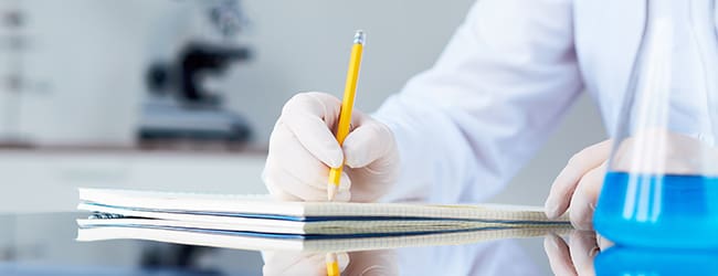 Scientist sketching on a notebook