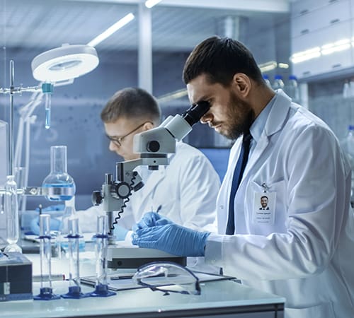 Scientist looking through a microscope